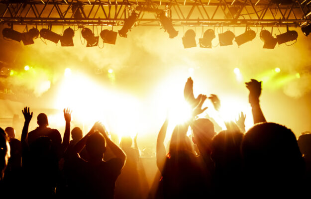 Rock,Concert,,Silhouettes,Of,Happy,People,Raising,Up,Hands